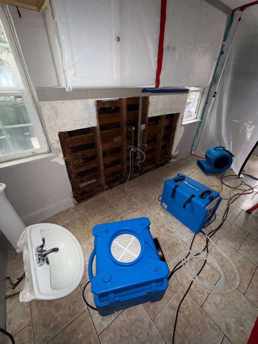 Containment, air scrubber and air movers set up after wall removal